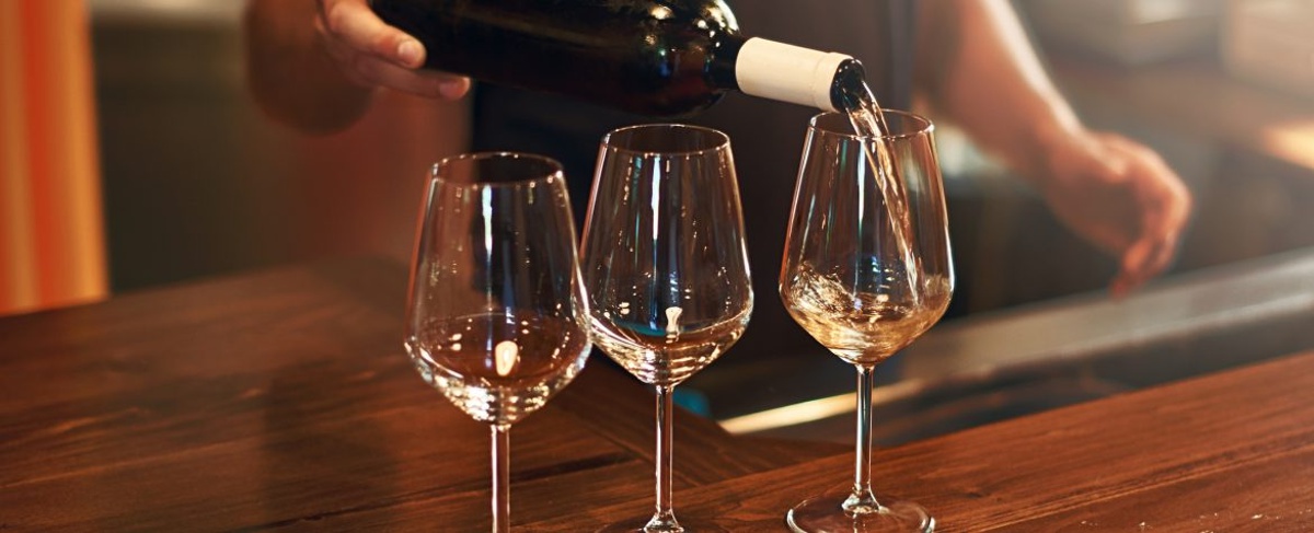 Sommelier fills the glasses during pinot gris wine tasting at a winery on The Urban Wine Trail in Santa Barbara.